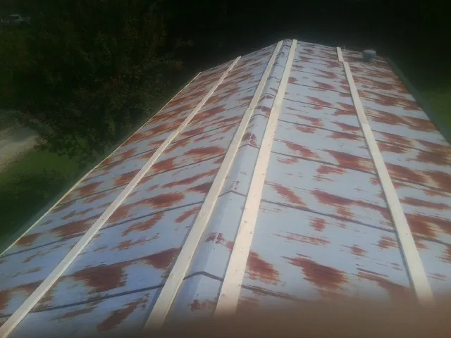 Rusted metal roof panels with new wood purlins before replacement — Storm Damage Roof Repair in Tallassee by Roofing Brothers