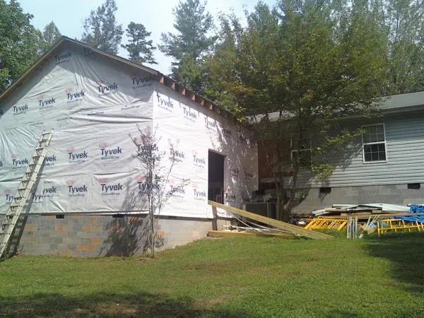Tyvek wrapped gable on a new room addition beside an existing home in Tallassee